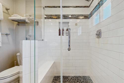 a bathroom with a glass shower with a toilet at Ola Vista in San Clemente