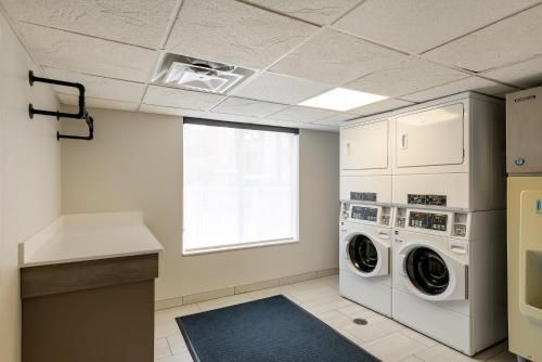 a laundry room with a washer and dryer at Holiday Inn Express Hotel & Suites - The Villages by IHG in The Villages