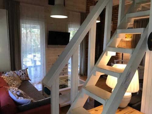 a staircase in a tiny house with a living room at Domki nad morzem Sasino Mojo Miodno Checz in Sasino