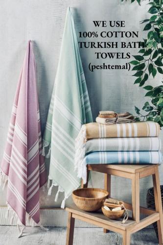 a towel rack with towels on it next to a surfboard at Your Downtown Cozy Studio With Backyard Unit C in Phoenix