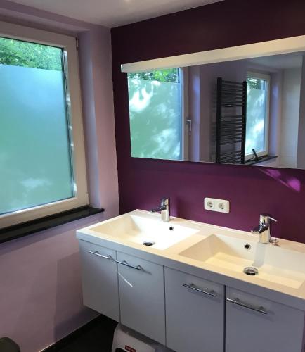 a bathroom with a white sink and a mirror at Bungalowpark Simpelveld - Delta 121 in Simpelveld