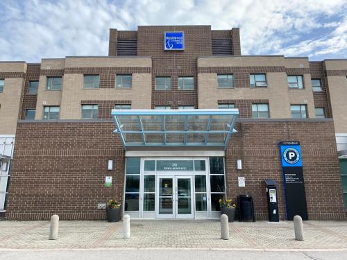 a large brick building with a large door at Residence & Conference Centre - Hamilton in Hamilton
