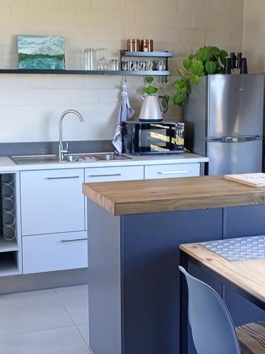 a kitchen with a sink and a counter top at Two Lakes in Bettyʼs Bay