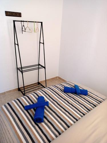 a cross and two blue objects on a striped rug at Maison de vacances 3 chambres en Medina in Chefchaouene