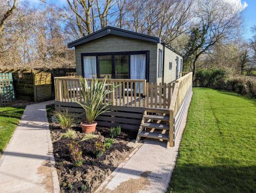 a tiny house with a porch and a deck at Sarn Y Glyn in Mid Wales Cambrian Mountains near Llanidloes Powys in Caersws