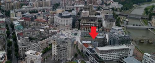 an aerial view of a city with a red arrow on a building at Alexandar Square Suites in Skopje