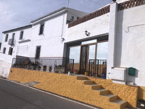 a white building with stairs in front of it at Large 1 bed apartment in the beautiful countryside in Rute