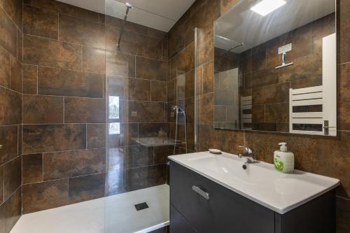 une salle de bain avec un lavabo et une douche dans l'établissement Cosy et Mer - Piscine partagée, au Cap d'Agde