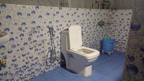 a bathroom with a toilet and a shower at Kedarnath Wildlife Resort in Gupta Kāshi