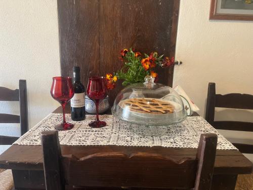 a table with a plate of waffles and two wine glasses at B&B Camelia in Camugnano