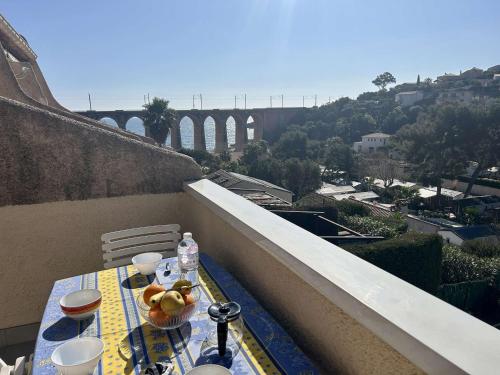 - une table sur un balcon avec vue sur un pont dans l'établissement Studio mezzanine climatisé proche plage avec terrasse et parking à Saint-Raphaël - FR-1-226A-162, à Saint-Raphaël