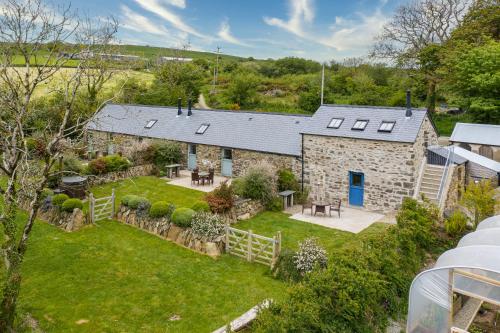 an aerial view of a stone house with a yard at Preseli Hills Cottages - Luxury 5 star Cottages in Pembrokeshire in Mynachlogddu
