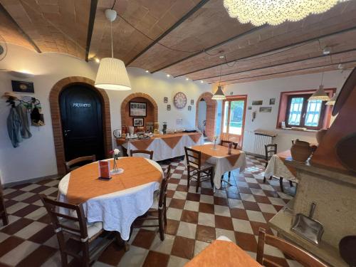 a restaurant with tables and chairs in a room at Mancino in Poggibonsi