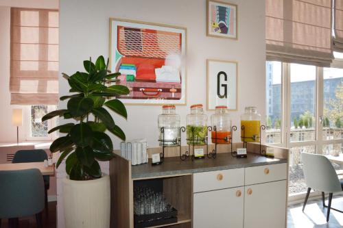 a room with a table with jars and a plant at Garner Hotel Essen - Handelshof by IHG in Essen