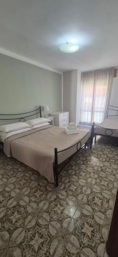 a bedroom with a large bed in a room at Finestra sul porto in Marina di Camerota