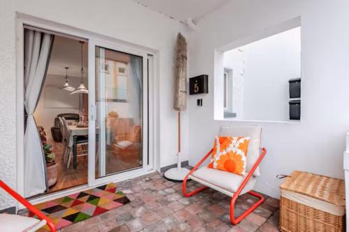a living room with a chair and a table at Harbour Sound Apartment, Ballycastle, Causeway Coast in Ballycastle