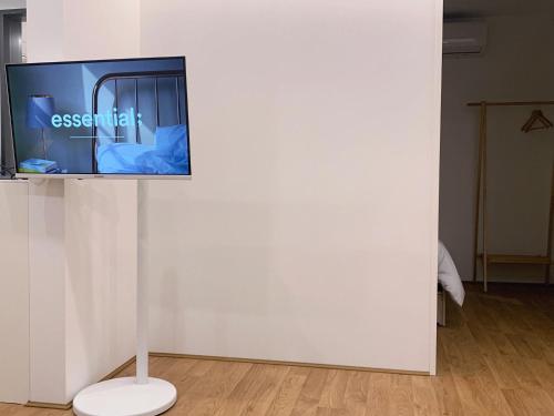 a tv on a stand on a white wall at Mangwon Hangang Park House 3 rooms or one room in Seoul