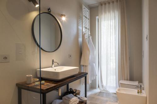 a bathroom with a sink and a mirror at Casale Oleo in Montiano