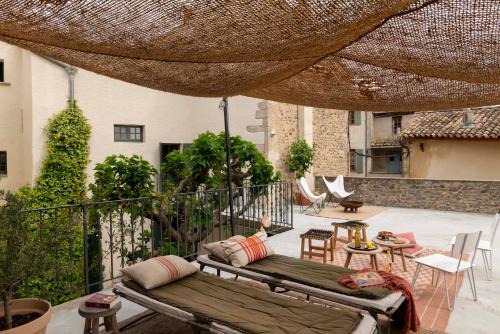 a patio with a couch and a table and chairs at la Perroya in Visan