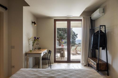 a bedroom with a bed and a desk and a table at Casale Oleo in Montiano