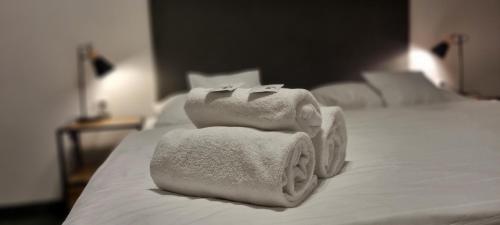 Un ou plusieurs lits dans un hébergement de l'établissement Hotel Legie