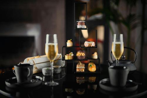 a table with two glasses of champagne and food at Penha Longa Resort in Sintra