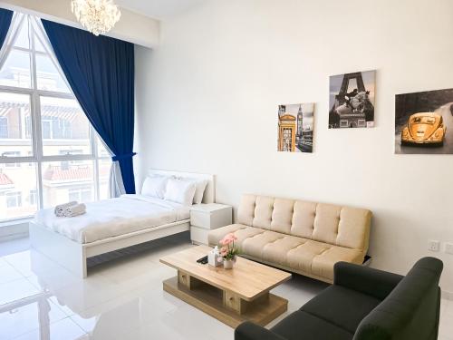 a living room with a couch and a bed at MK Residence JVC in Dubai