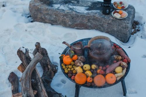 a basket of fruit on a table in the snow at The Long Circle House in Yanqing