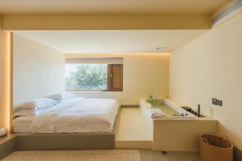 a bedroom with a bed and a window at The Long Circle House in Yanqing