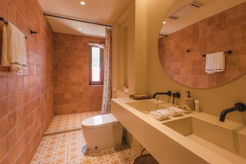 a bathroom with a tub and a sink and a mirror at The Long Circle House in Yanqing