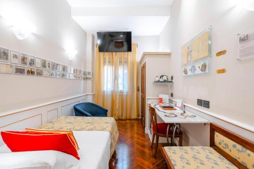 a hotel room with a bed and a desk at Art Hotel Commercianti in Bologna