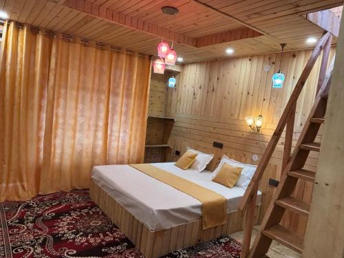 a bedroom with a bed in a wooden room at Apple Land by Naavagat in Jibhi