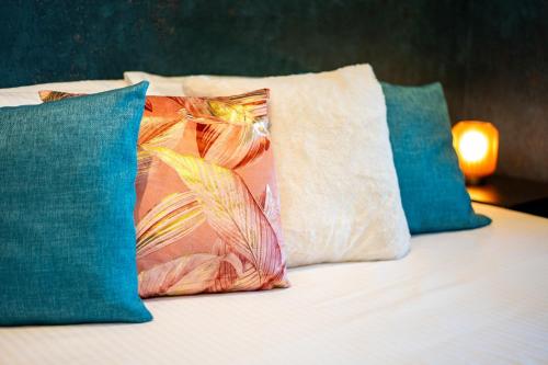 a bed with two pillows and two pillows on it at Huswell - Chic Studio with Garden in Central Ghent in Ghent