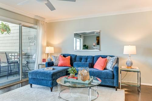 a living room with a blue couch and a glass table at Waterfront Lake Norman Retreat with Pool Access! in Davidson