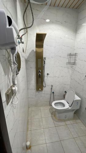 a bathroom with a toilet and a phone on the wall at فندق مروج الماس in Abha