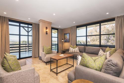 a living room with couches and chairs and windows at Midgard in Khorusepa