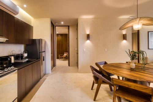 a kitchen and dining room with a wooden table at Amina Wind Resort by Tasman in Salinas