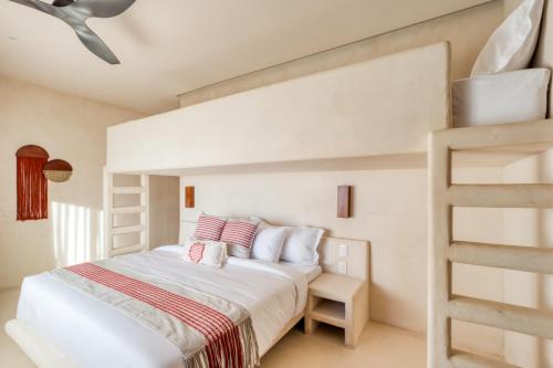 a white bedroom with a bunk bed and a ladder at Amina Wind Resort by Tasman in Salinas