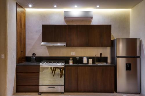 a kitchen with a stainless steel refrigerator and a stove at Amina Wind Resort by Tasman in Salinas
