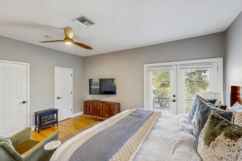 a bedroom with a bed and a ceiling fan at Sailfish Sanctuary in Lakeway