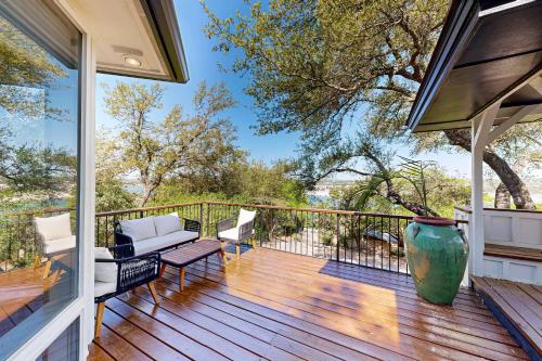 a porch with a couch and chairs on a deck at Sailfish Sanctuary in Lakeway