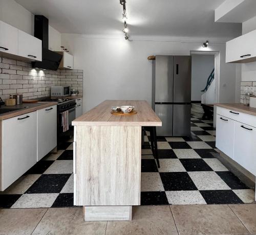une cuisine avec un îlot en bois au milieu dans l'établissement Charmante maison Canétoise proche plage et commodités !, à Canet