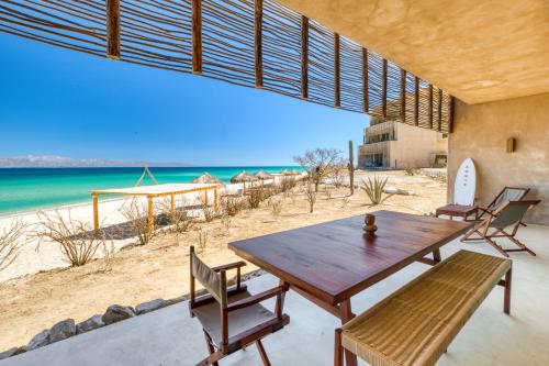 a dining room with a table and chairs on the beach at Amina Wind Resort by Tasman in Salinas