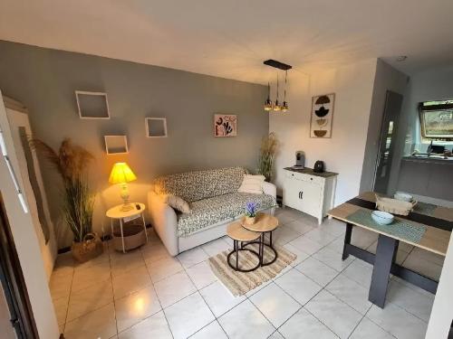 un salon avec un canapé et une table dans l'établissement Appartement confortable à Bœrsch, 30 m² avec piscine, à Bœrsch