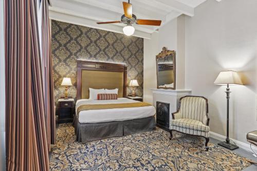 a hotel room with a bed and a chair at Place D'Armes Hotel in New Orleans