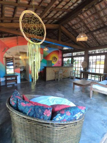 a room with a large basket in a room with a mural at Mangará Hostel e Hospedaria in Ilhabela