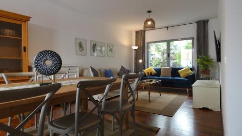 a kitchen and living room with a table and chairs at Madeira Serenity Cottage in Funchal