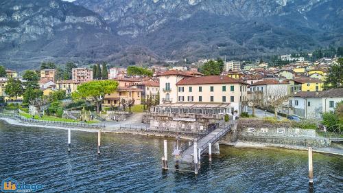 a town with a dock in the water with mountains at Blue Heaven in Lierna