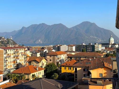 a city with buildings and mountains in the background at Attico Vista Lago, Relax & Wi-fi in Intra