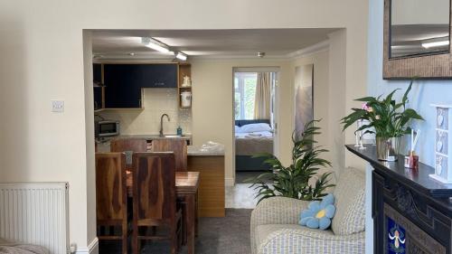 a kitchen and a living room with a dining room at 4 Queens Gardens Seaside Apartment in Eastbourne